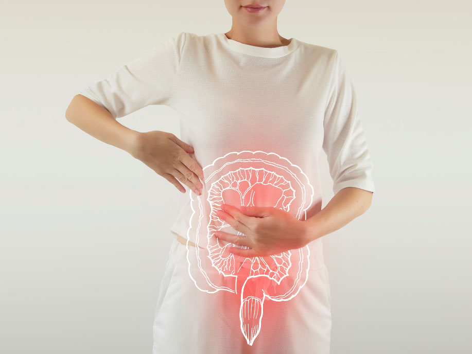An outline of the human bowel is superimposed on a woman as she holds her stomach